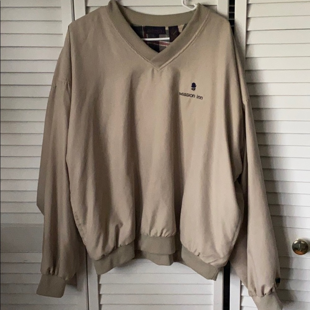 Tan windbreaker with flannel on the inside
